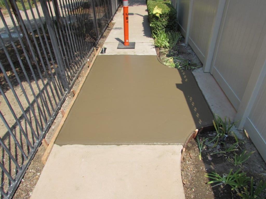 Replaced concrete walkway section after trip hazard repair