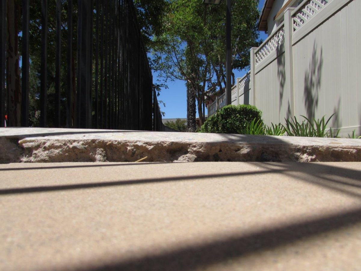 Raised concrete walkway lip before trip hazard repair